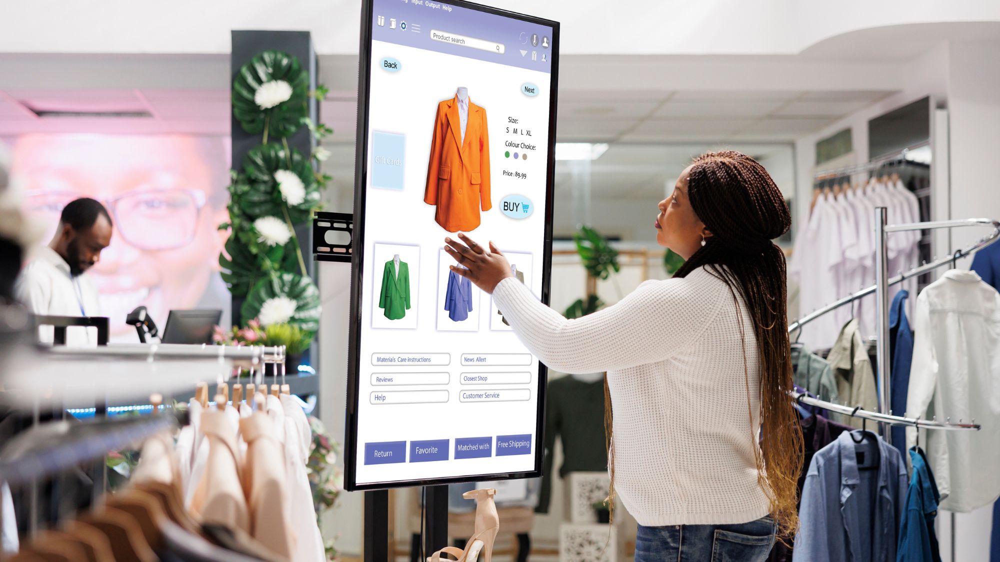 A woman using a digital signage in a clothing store