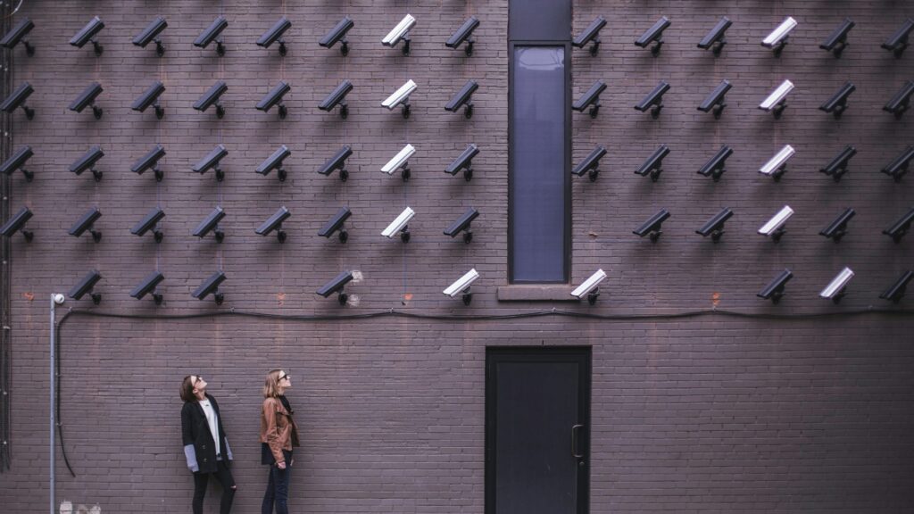 Multiple modern CCTV tower systems monitoring on a wall