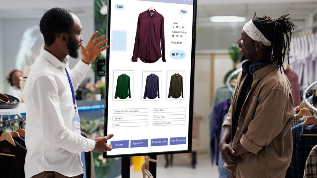 Two guys using a digital signage in a clothing store