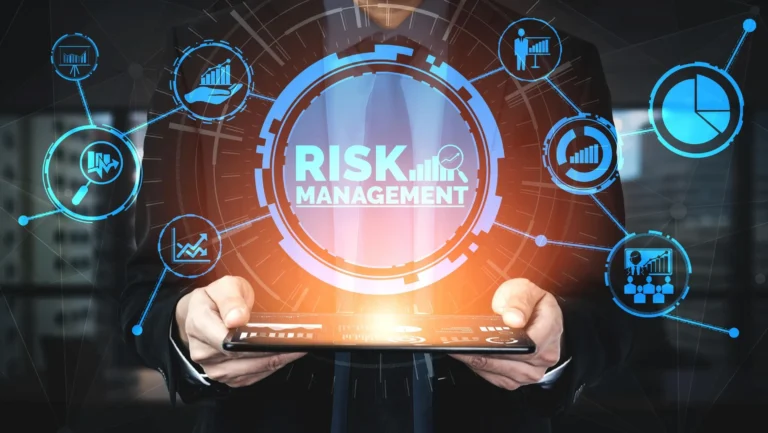 A person in a suit holding a tablet, with a holographic interface displaying "Cybersecurity RISK MANAGEMENT" in the center, surrounded by icons representing data analysis, charts, and growth metrics.